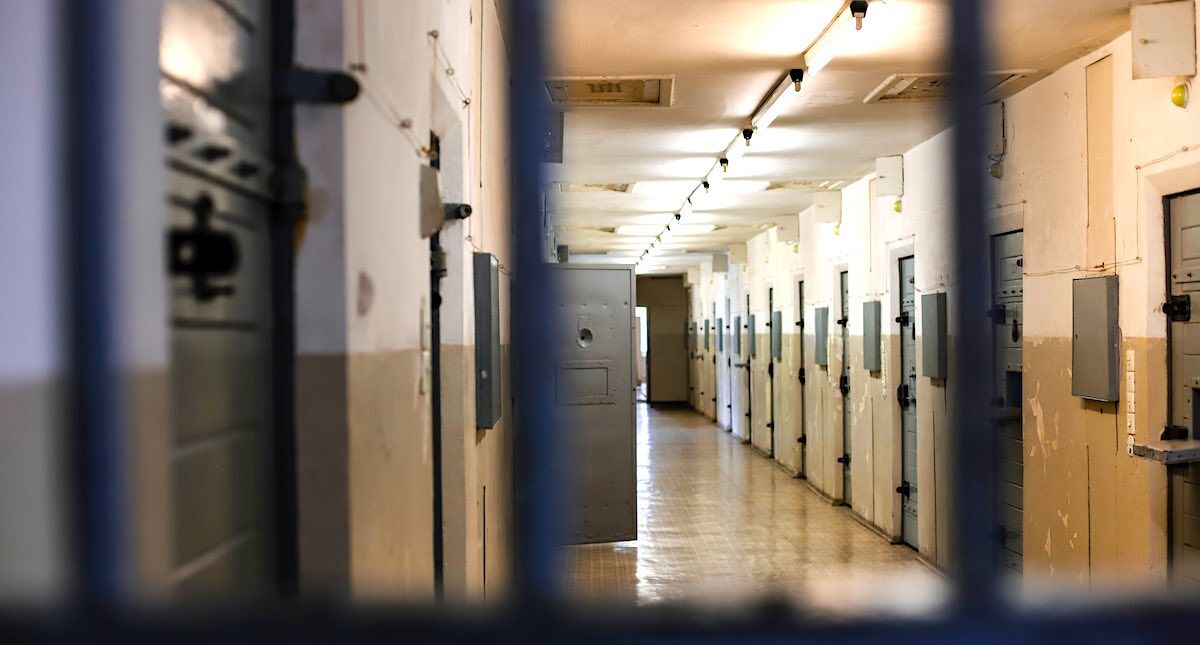 prison cells with one door open which seems like a prison escape