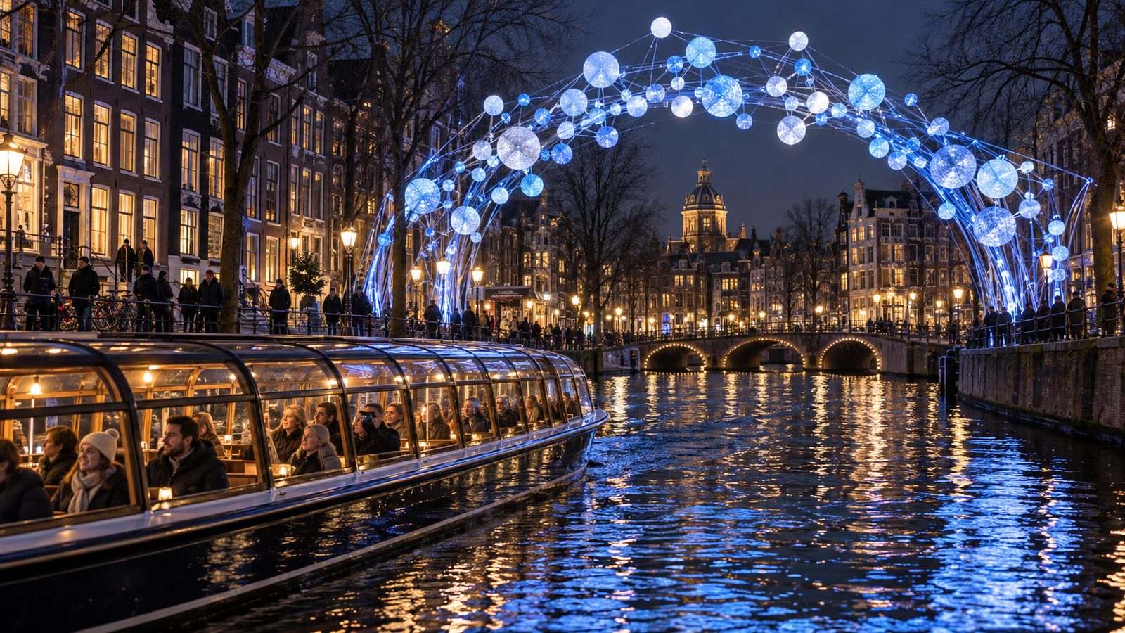 Amsterdam Light Festival at night in December with a heated canal cruise boat and a glowing light artwork over the canal